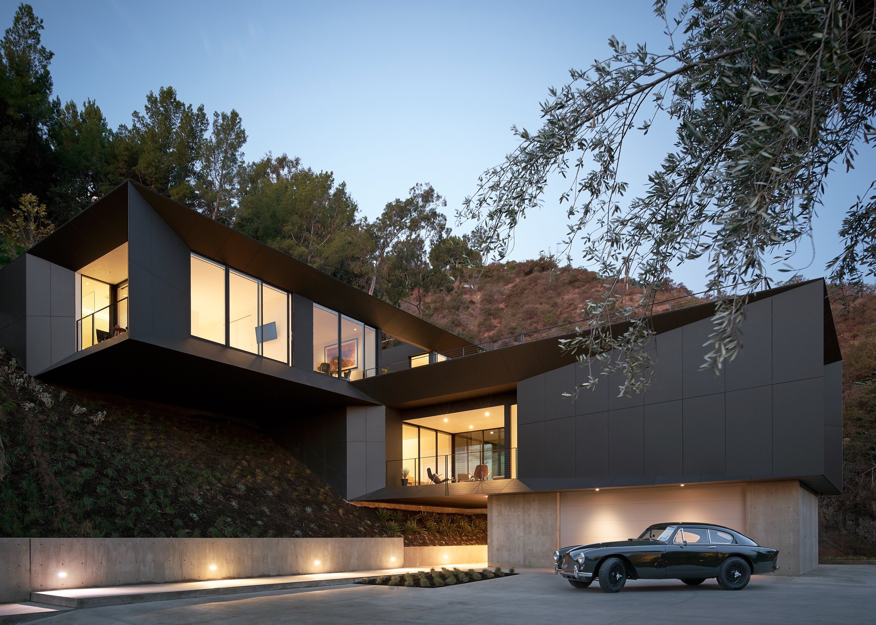 black house with illumination located on a hill 