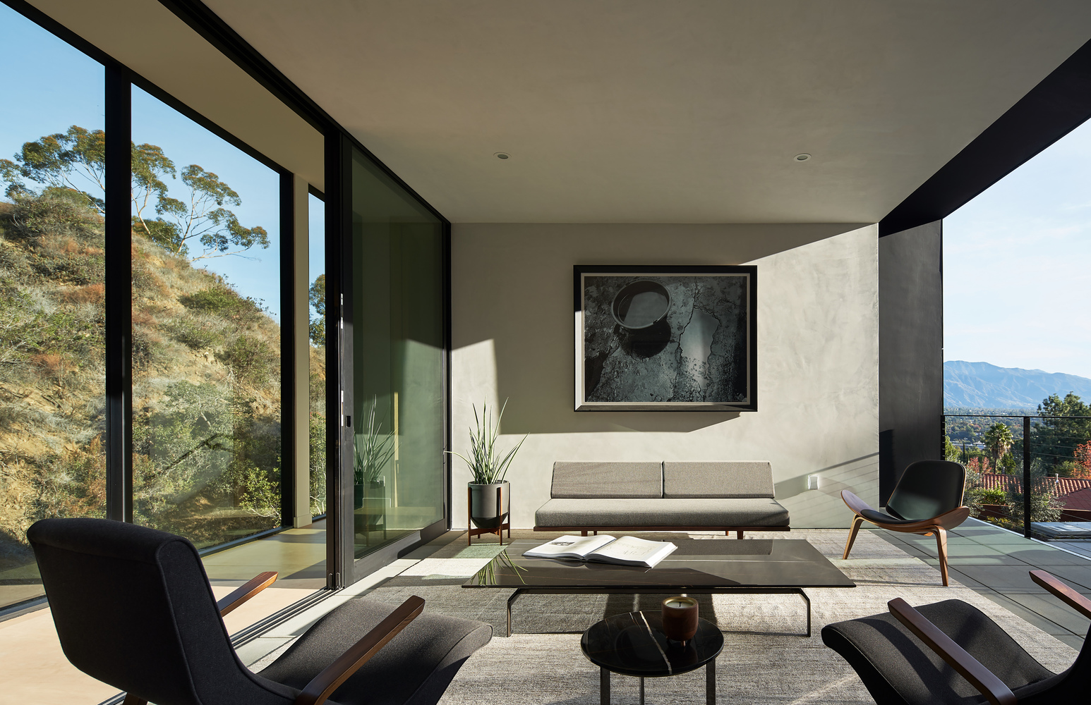 living room with big glass windows let the sunlight enters the room 