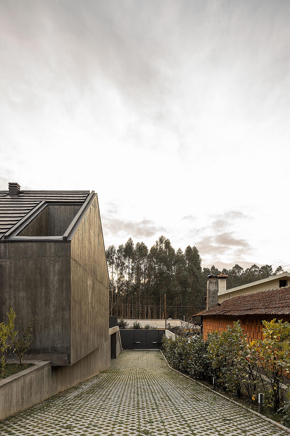 house with triangular roof surrounded by green trees 