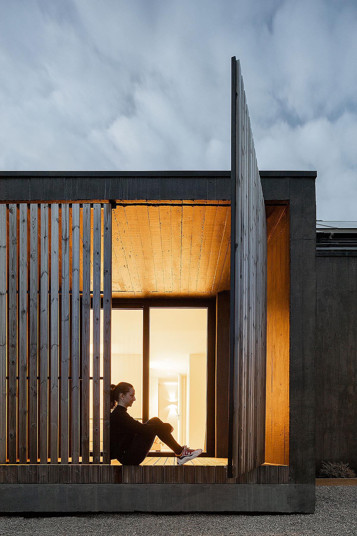 girl sitting at the deck go the house 