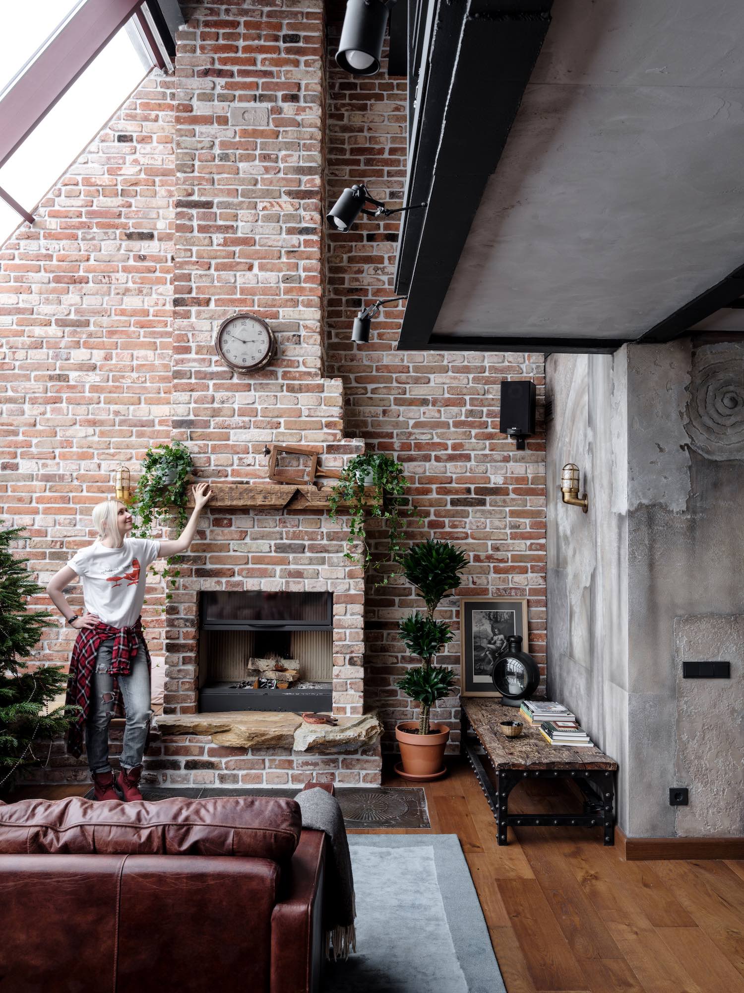 Russian blonde girl standing by fireplace 